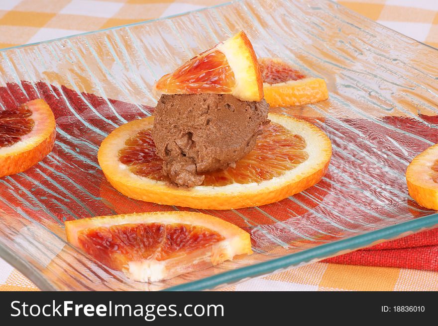 Chocolate mouse and orange served over a glass plate. Chocolate mouse and orange served over a glass plate.
