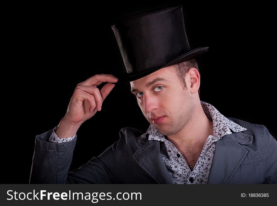 Emotional portrait of the serious man in a black top-hat
