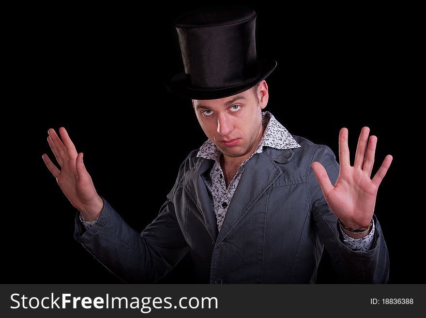 Emotional portrait of the serious man in a black top-hat