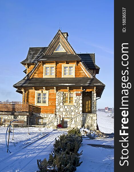 Front of the traditional house in Polish moutain in wintertime at frosty and sunny morning. Front of the traditional house in Polish moutain in wintertime at frosty and sunny morning.