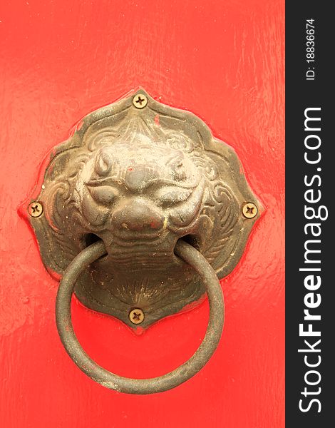 Oriental door knob on red background