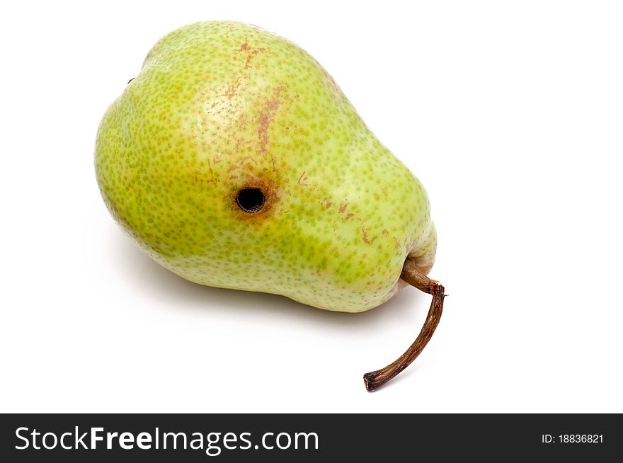 Pear with black hole over white background