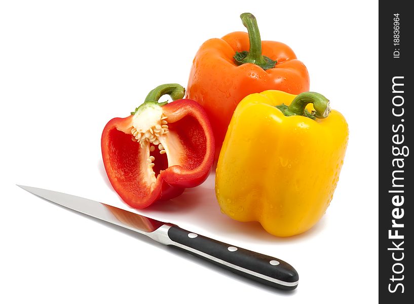 Bell peppers and knife isolated on white.