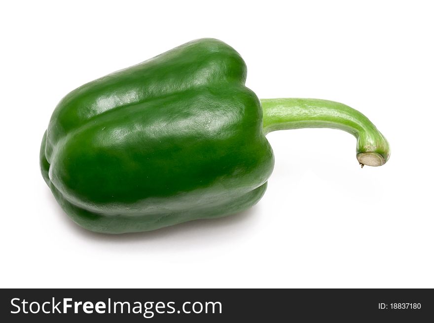 Single green paprika over a white background