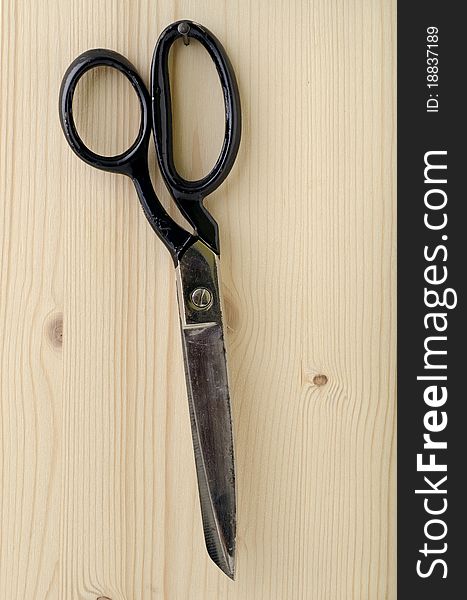 Tailor scissors hanging on the nail