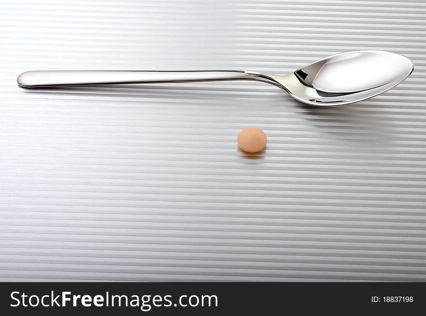 Spoon with a pill near