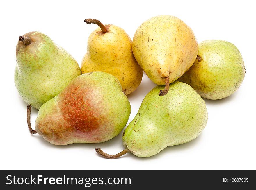Green and yellow pears over white background