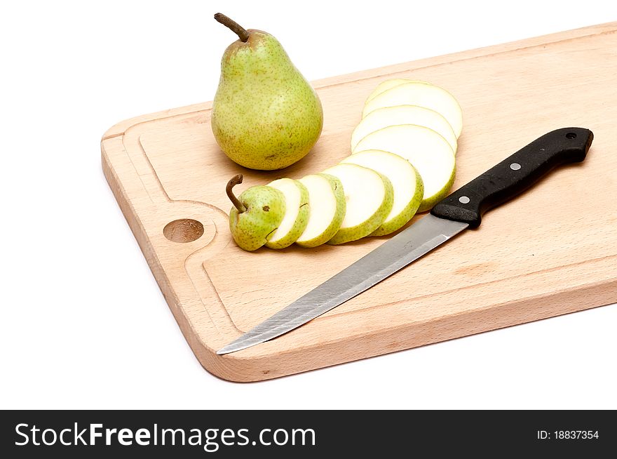 Pear and slices with knife on chopping board over white background