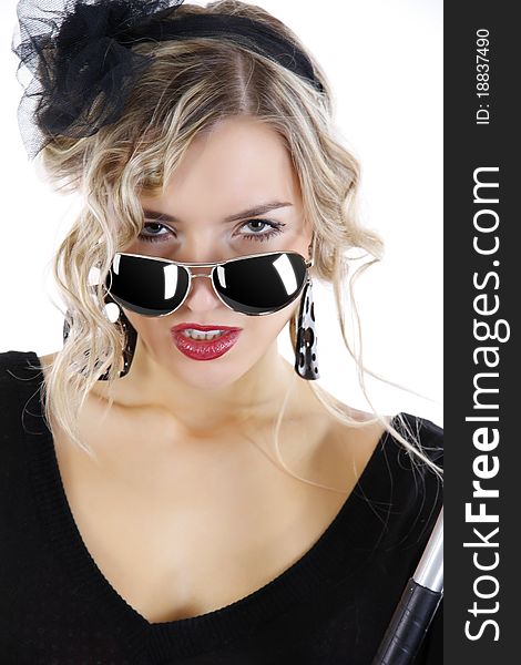 Portrait of a beautiful girl in sun glasses with an aggressive look