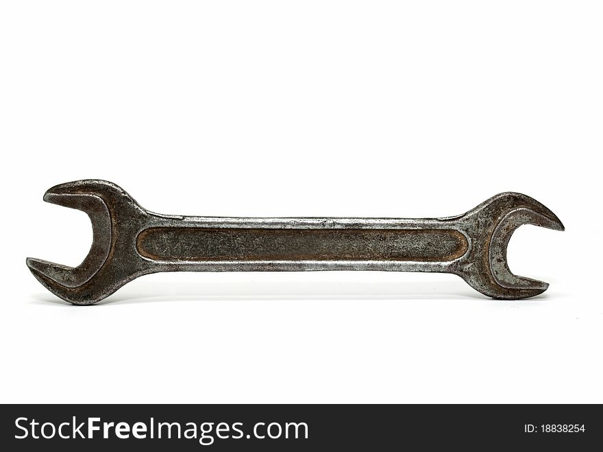 Old wrench on a white background, close-up.