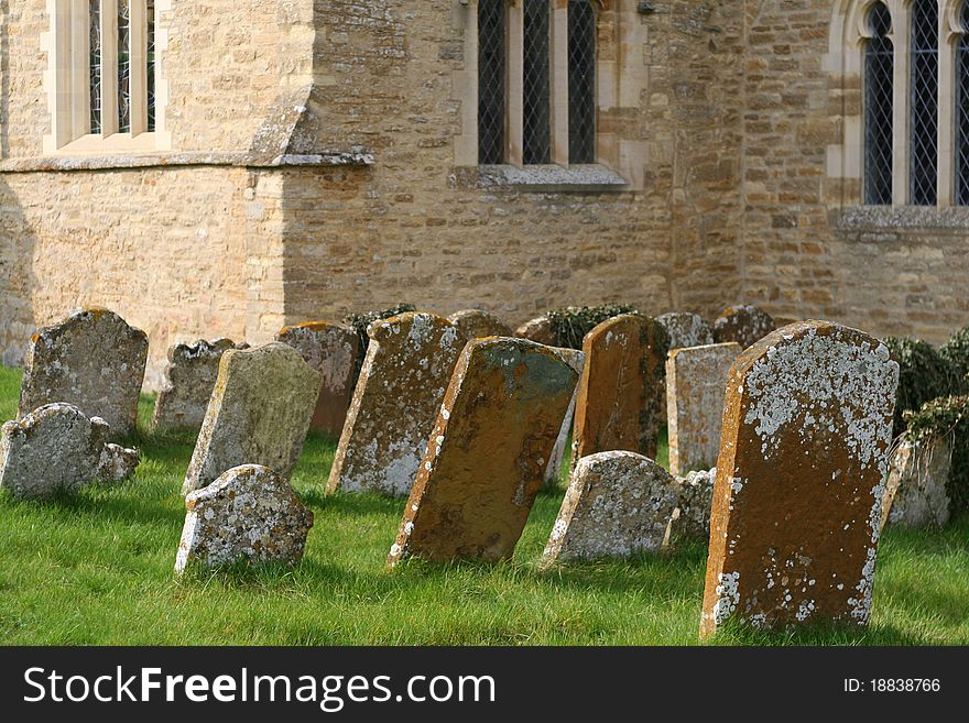 Old leaning gravestones in a churchyard.