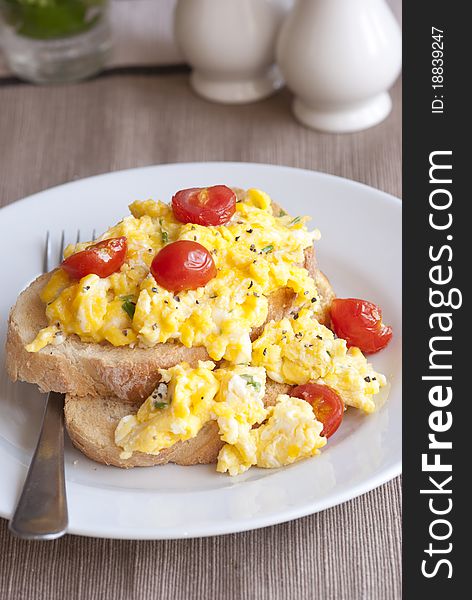 Toast with scrambled eggs and cherry tomatoes. Toast with scrambled eggs and cherry tomatoes