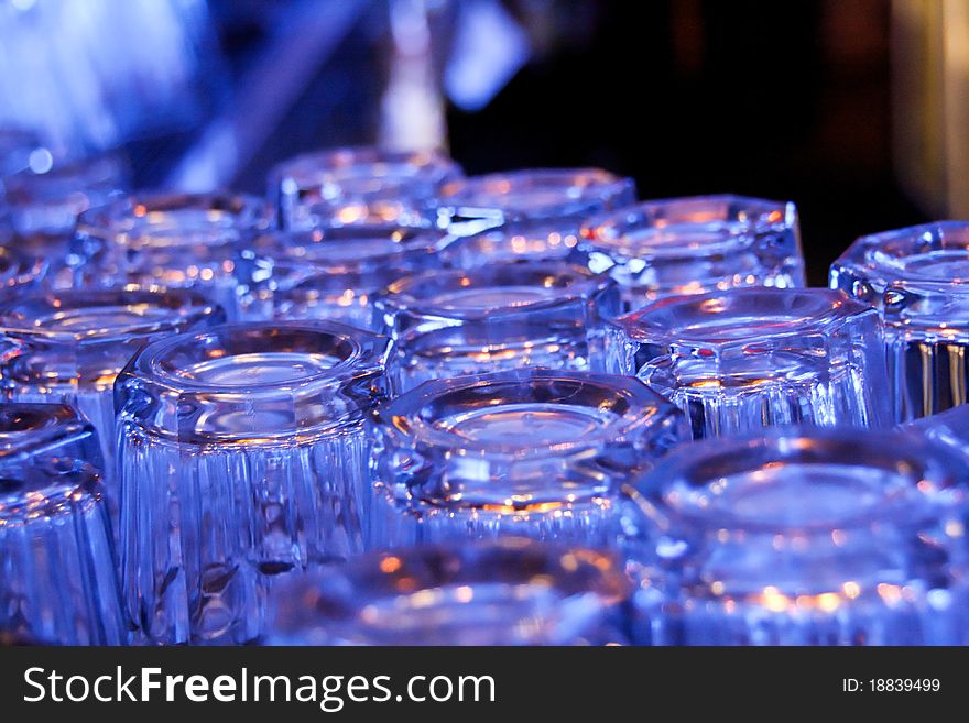 Glasses stacked on a counter in blue light. Glasses stacked on a counter in blue light