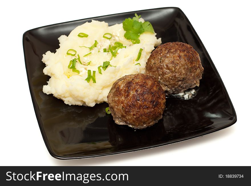 Meatballs with mashed potato on the plate closeup