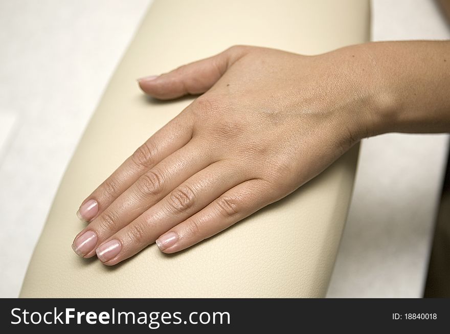 Hand with natural manicure in salon