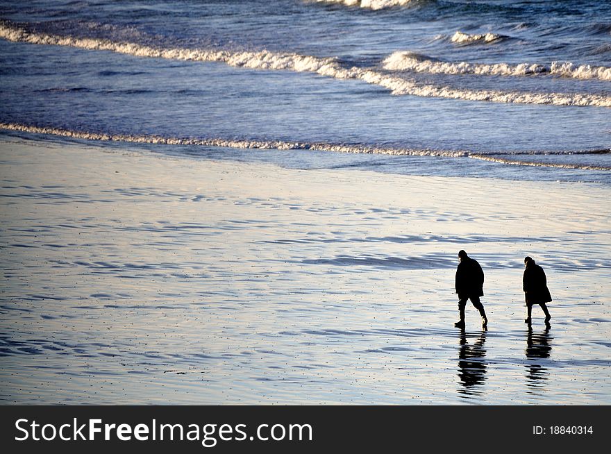 Shot of adult couple walking on the beach of Saint-Malo in brittany, france. Shot of adult couple walking on the beach of Saint-Malo in brittany, france