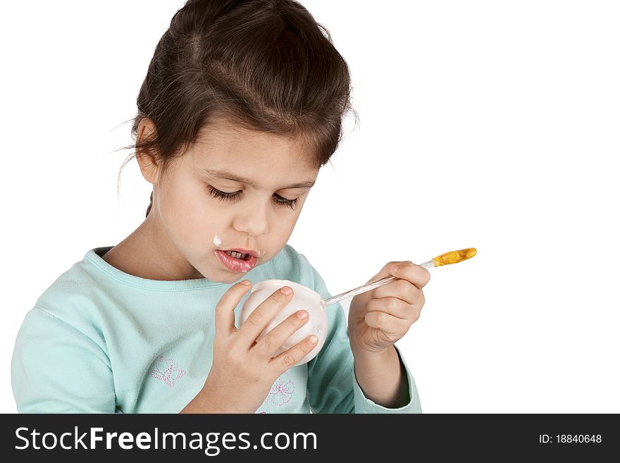 Girl eating yogurt isolated on white background