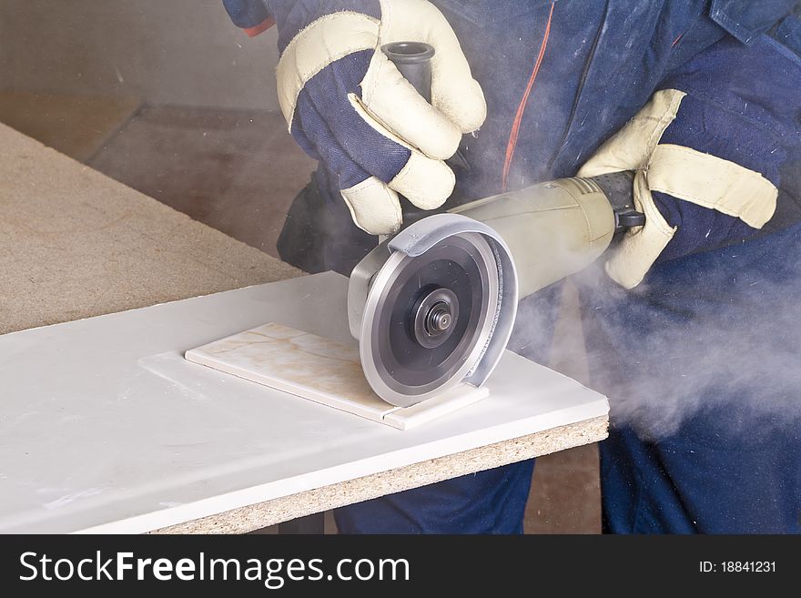 A man working with grinder, close up on tool, hands and sparks, real situation picture. A man working with grinder, close up on tool, hands and sparks, real situation picture