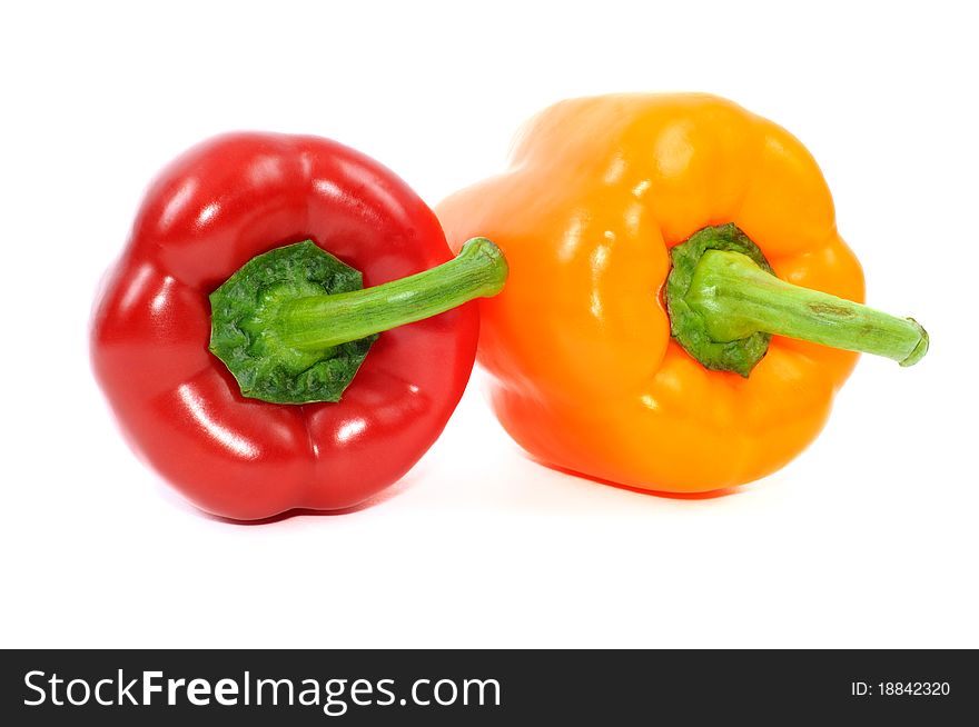 Red and yellow paprika peppers isolated on a white background