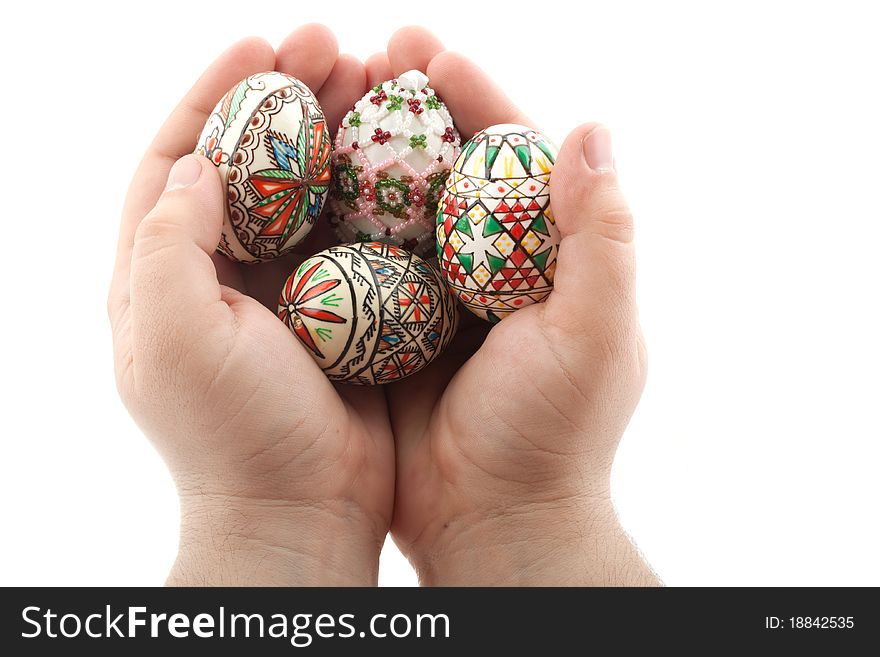 Traditional easter eggs from Transylvania holded in hands with care, isolated on white background
