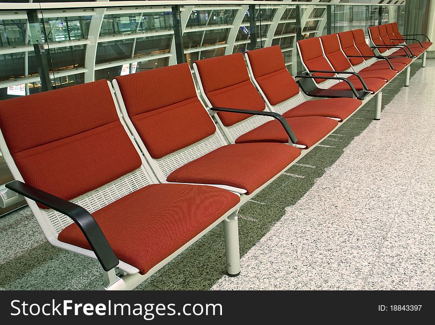 Empty airport seats in airport departure lounge.