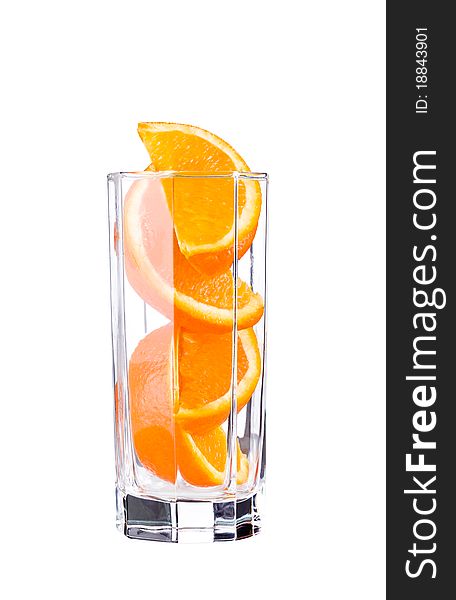 Orange sliced in glass isolated on white. Orange sliced in glass isolated on white