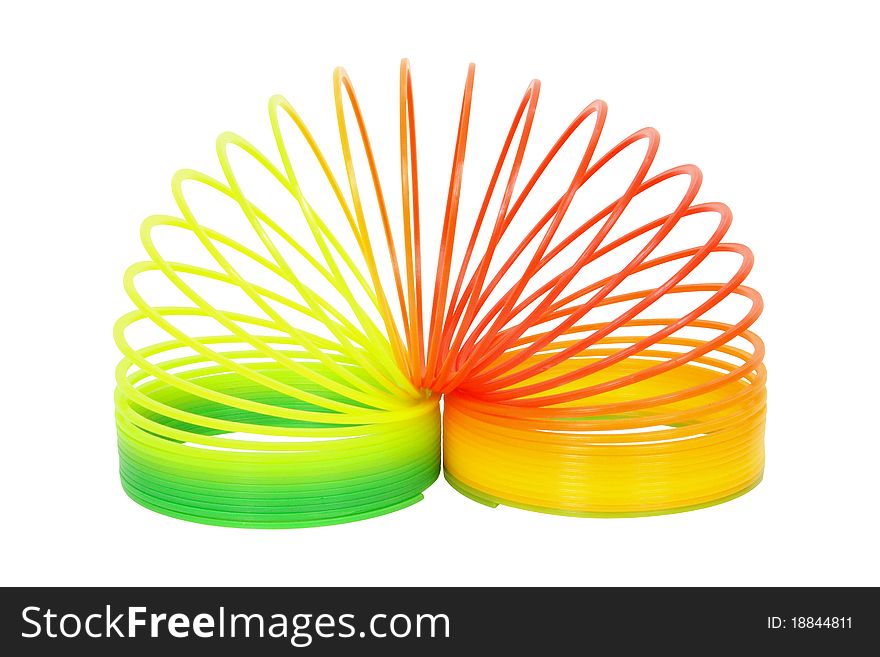 A multicoloured plastic spiral forming an arch on a white background. Horizontal format. Clipping path included. A multicoloured plastic spiral forming an arch on a white background. Horizontal format. Clipping path included.