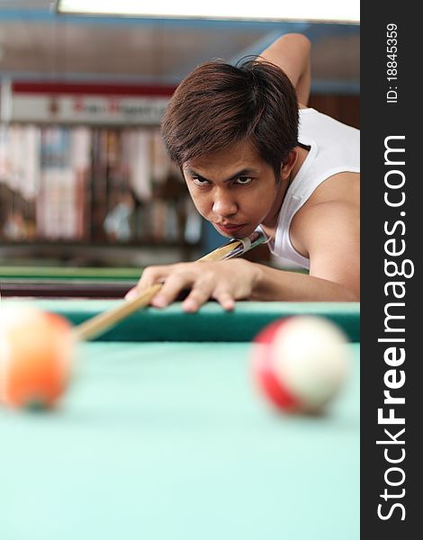 Billiard player in deep concentration