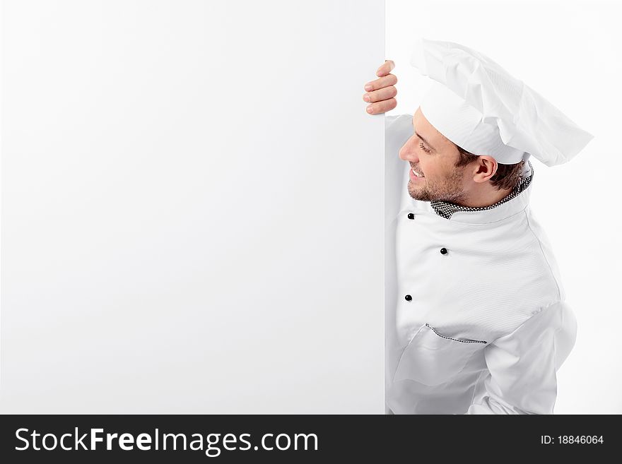 Attractive cook looks at a blank white background. Attractive cook looks at a blank white background