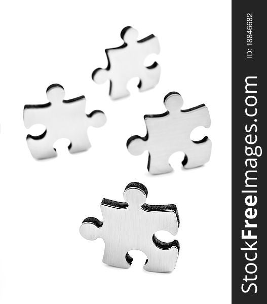 Stainless steel puzzles pieces on white background