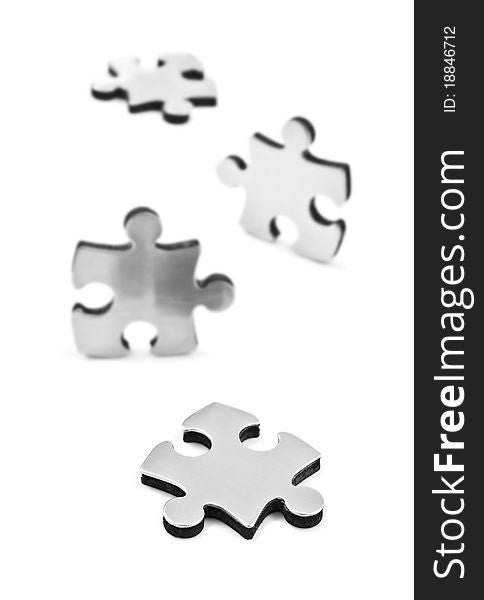 Stainless steel puzzles pieces on white background