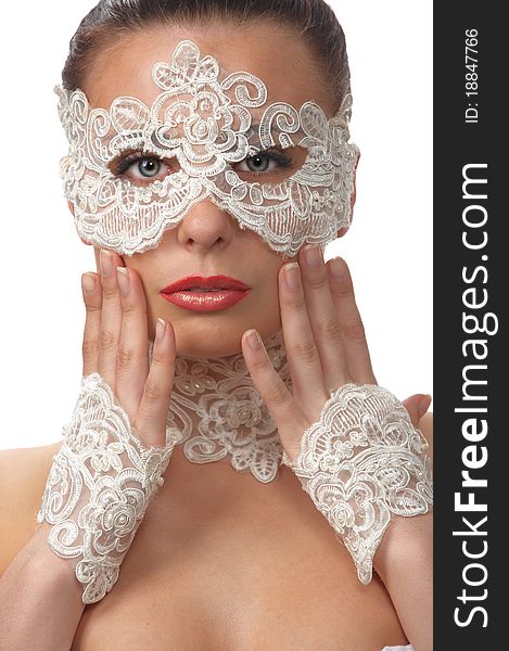 Woman with tender face in lace mask over her eyes