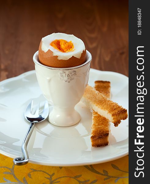 Boiled egg in an eggcup and toast