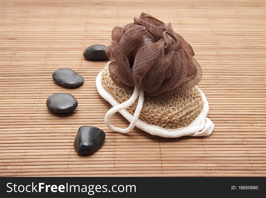 Massage sponge and stones on mat