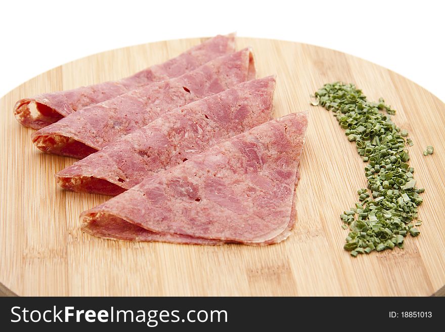 Corned beef with chives onto wood plates