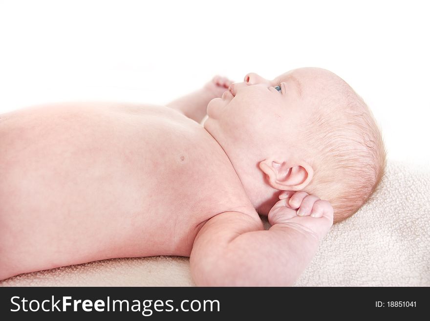 Baby laying down on a white background. Baby laying down on a white background