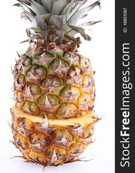 Pineapple - cut in half, in close up on white background