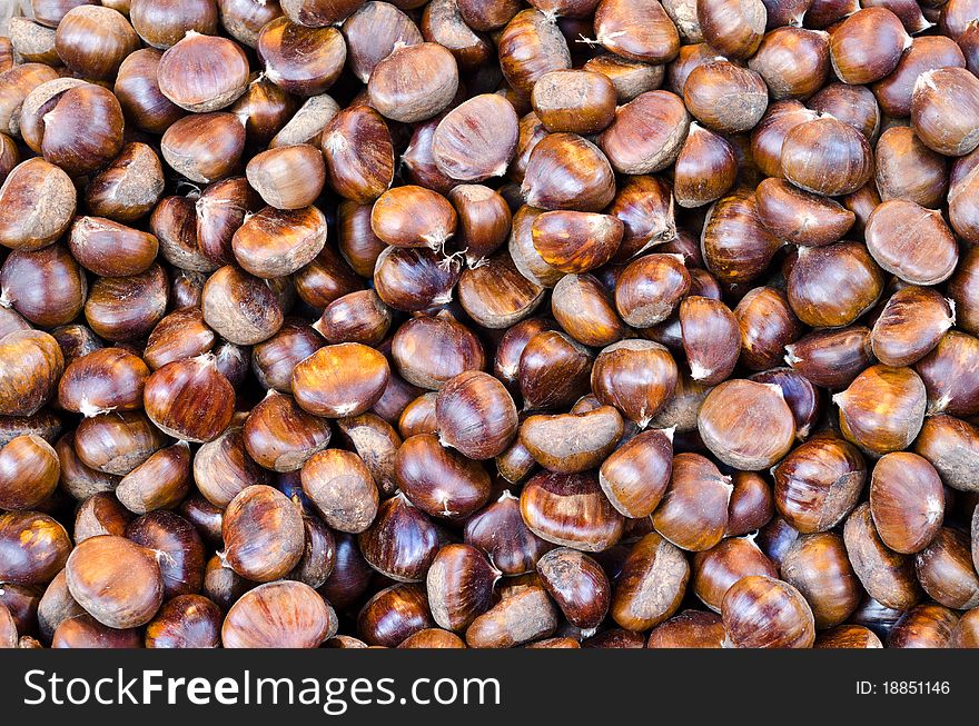 Bunch of brown non peeled edible chestnuts