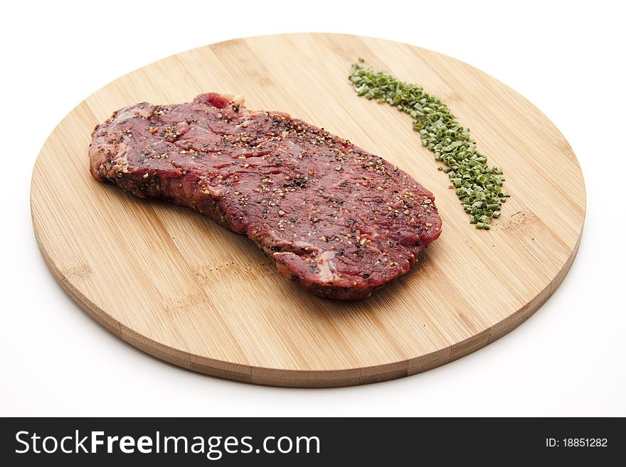 Steak seasoned with chives onto wood plates