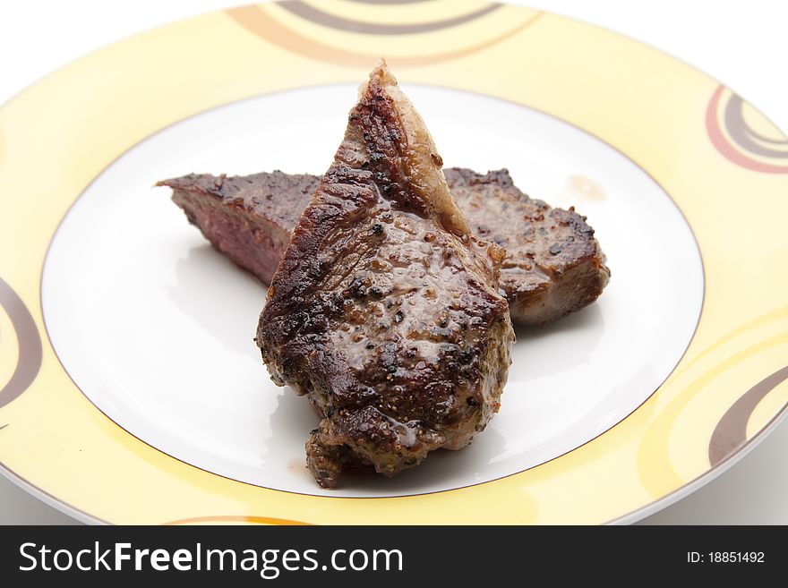 Seasoned steak and on ceramics plate