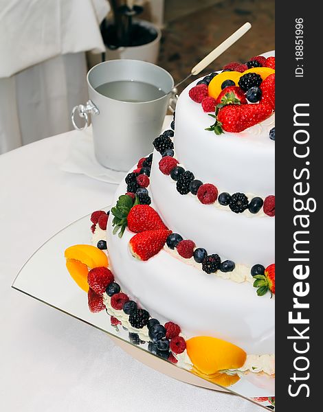 Fresh wedding fruitcake with strawberries, raspberries, blackberries, peaches and blueberries