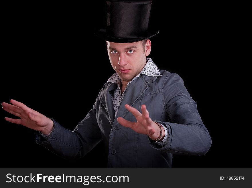 Emotional portrait of the young man in a black top-hat. Emotional portrait of the young man in a black top-hat