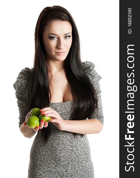 Young woman holding limes isolated on white