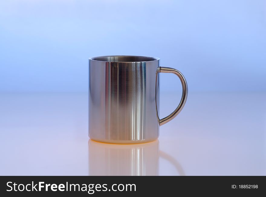 Metallic cup against the blue background