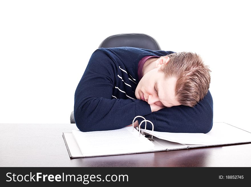 Young student sleeping on his paperwork, isolated on white