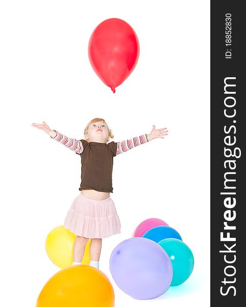 The little girl catches a balloon. The little girl catches a balloon