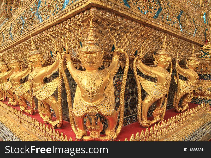 Gold ornamental patter statuettes in Grand palace, Bangkok, Thailand.