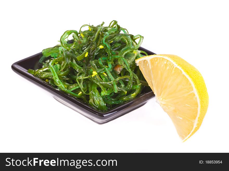 Plate with chuka salad and lemon