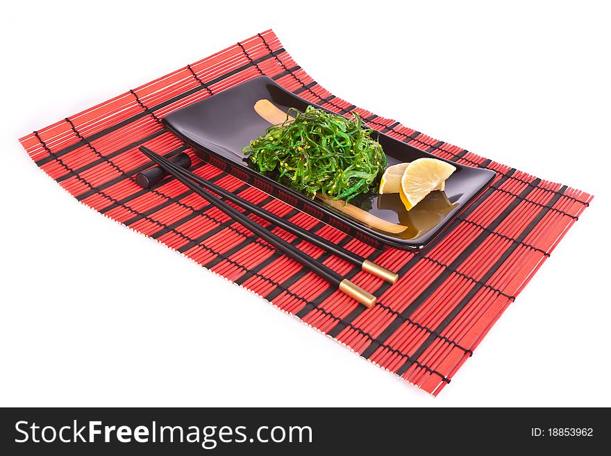 Plate with chuka salad on a red mat