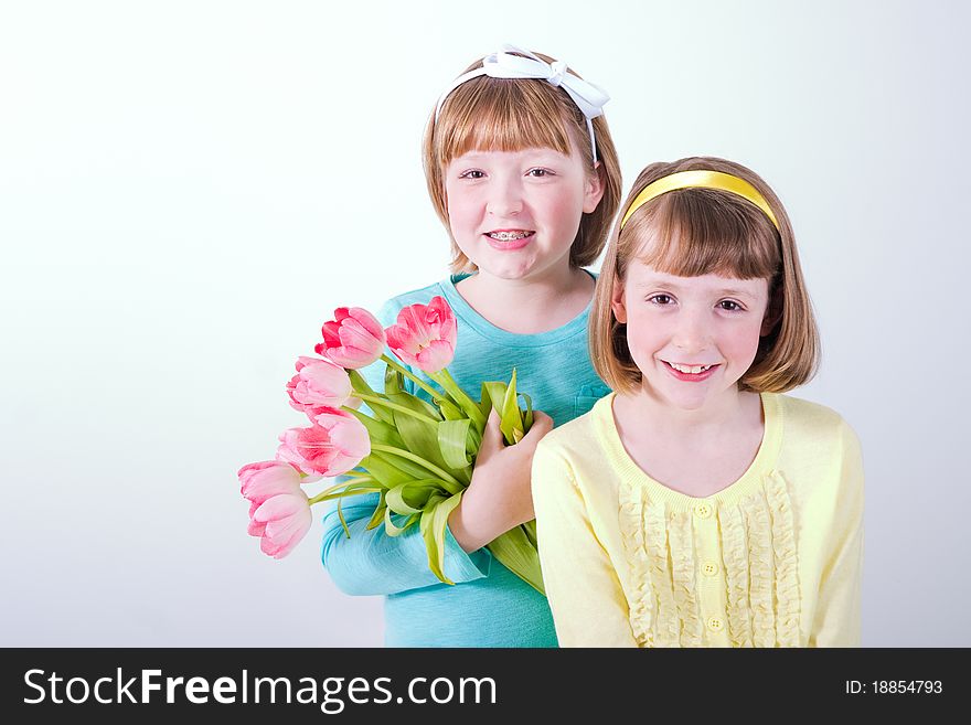 Little Girls Holding Bouquet Of Tulips